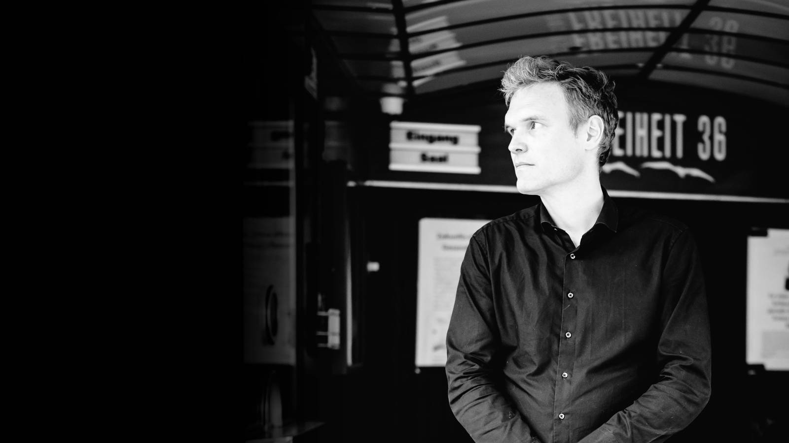 Robert Cibis in the entrance of the Freiheit 36 cinema, black and white