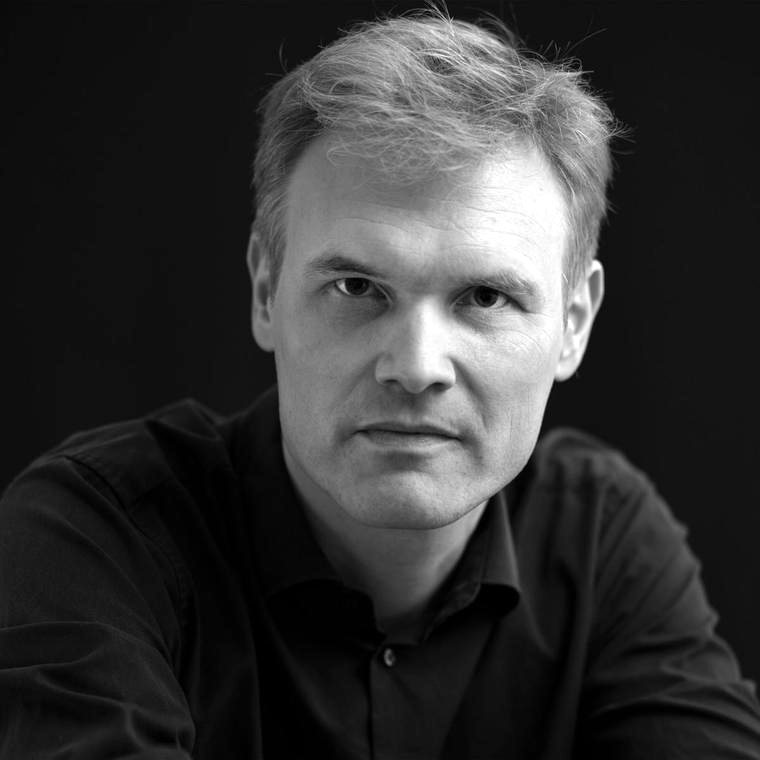 Portrait of Robert Cibis against a black background